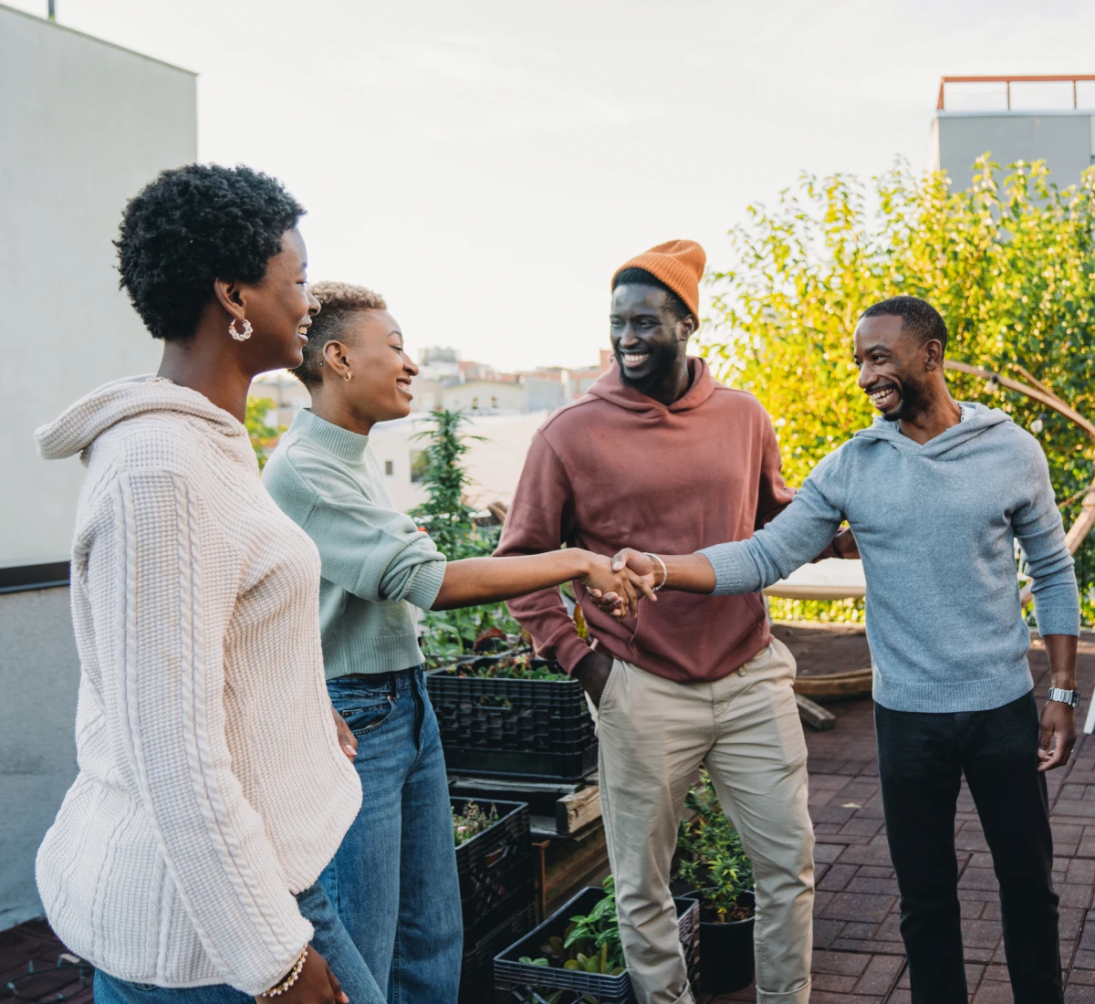 Group of people shaking hands outside